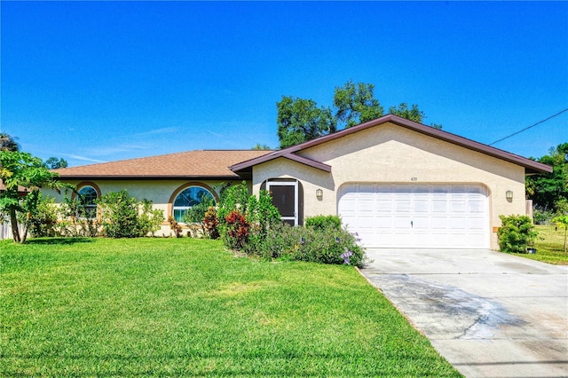 single story home with stucco siding, a front lawn, driveway, and a garage