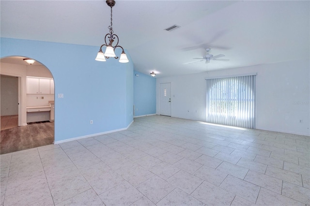 empty room featuring ceiling fan, visible vents, baseboards, arched walkways, and light tile patterned flooring