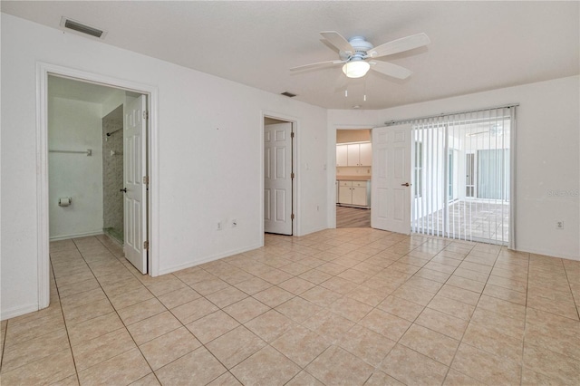 unfurnished room with a ceiling fan, visible vents, and light tile patterned flooring