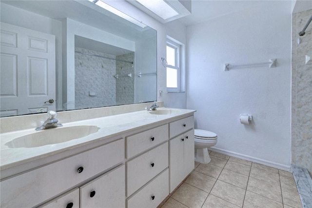 full bathroom with double vanity, toilet, a sink, and a tile shower