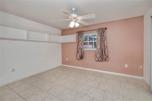 empty room featuring baseboards and ceiling fan