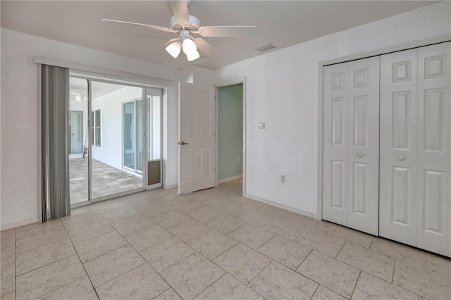 unfurnished bedroom with access to exterior, a ceiling fan, baseboards, visible vents, and a closet