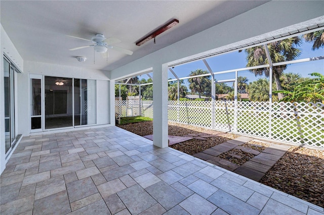 unfurnished sunroom with ceiling fan