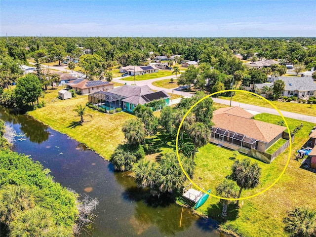 drone / aerial view with a residential view and a water view