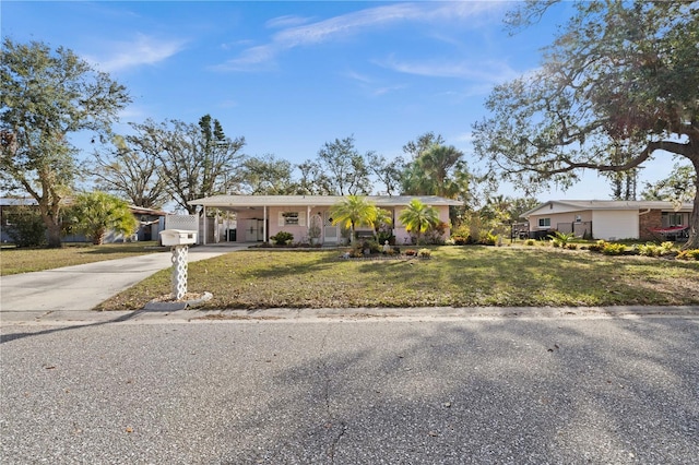 ranch-style house with a carport and a front yard