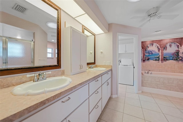 bathroom featuring visible vents, washer / clothes dryer, a garden tub, tile patterned flooring, and a sink