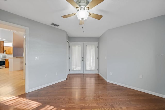 entrance foyer with baseboards, visible vents, wood finished floors, and french doors