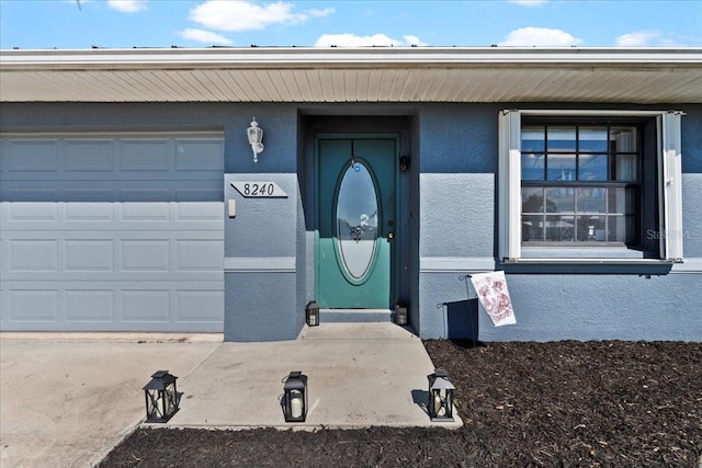 view of exterior entry with a garage