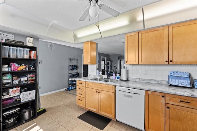 kitchen featuring light brown cabinetry, dishwasher, sink, backsplash, and ceiling fan