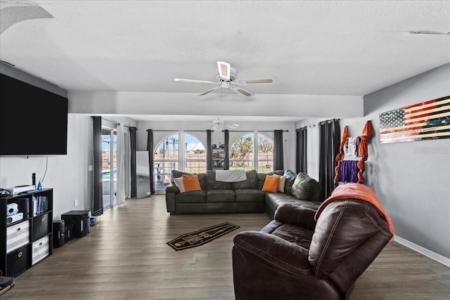 living room featuring a healthy amount of sunlight, hardwood / wood-style floors, and a textured ceiling