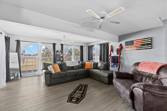 living room with wood-type flooring and ceiling fan