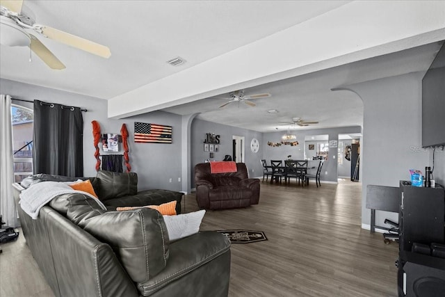 living room with a wealth of natural light, hardwood / wood-style floors, and ceiling fan