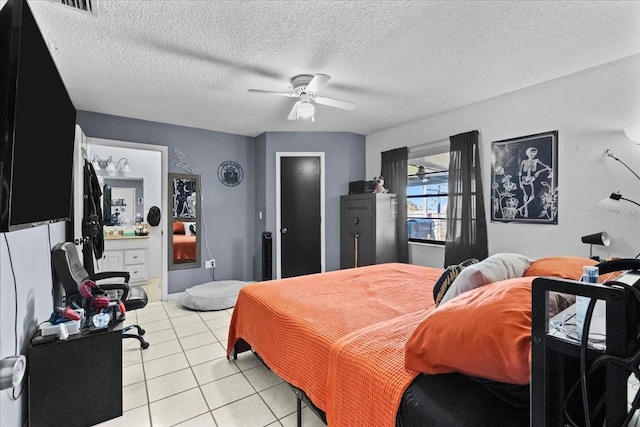 tiled bedroom with a textured ceiling and ceiling fan