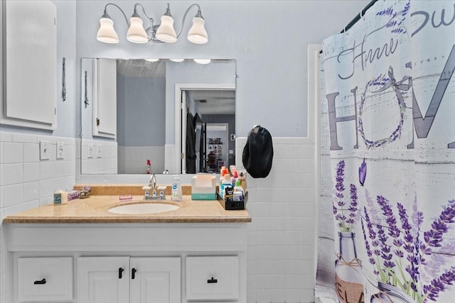 bathroom featuring vanity, tile walls, and curtained shower