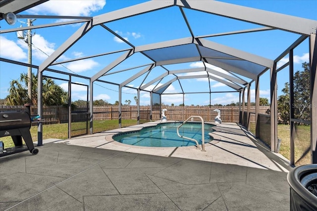 view of swimming pool with a lanai and a patio area