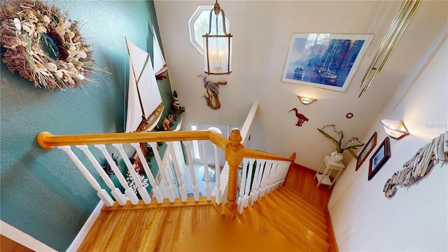 stairs featuring wood finished floors