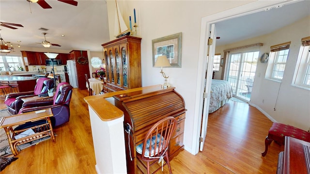 interior space featuring light wood-type flooring, visible vents, and baseboards