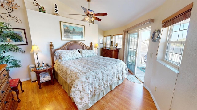 bedroom with access to outside, multiple windows, baseboards, and light wood-style flooring