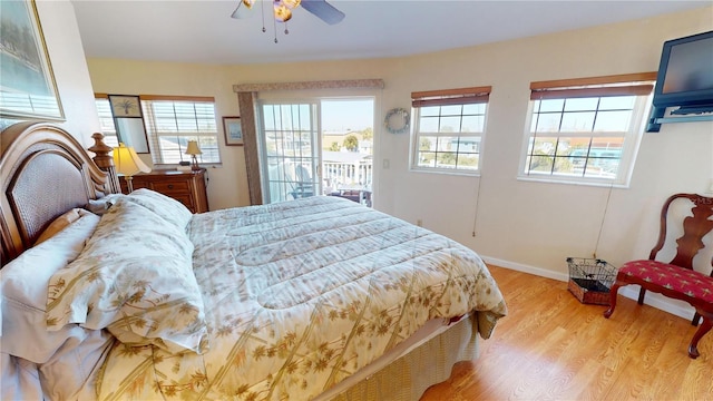 bedroom featuring access to exterior, light wood-style floors, baseboards, and ceiling fan