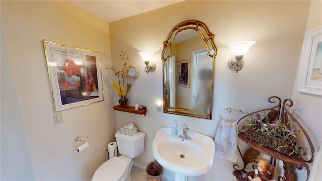 bathroom featuring a sink and toilet