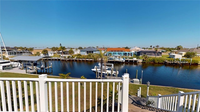 view of dock featuring a residential view, a water view, and boat lift