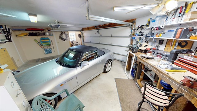 garage with a workshop area and a garage door opener