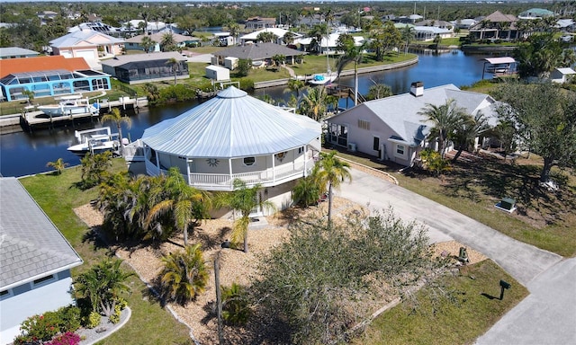 drone / aerial view featuring a water view and a residential view