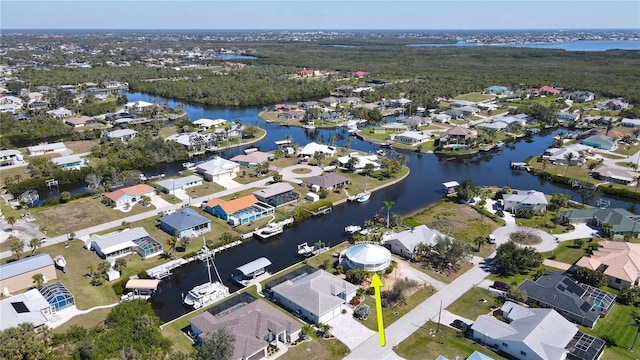 birds eye view of property with a water view and a residential view