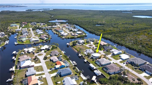 drone / aerial view featuring a residential view and a water view