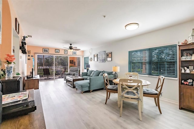 dining area with light wood-type flooring, baseboards, and a ceiling fan