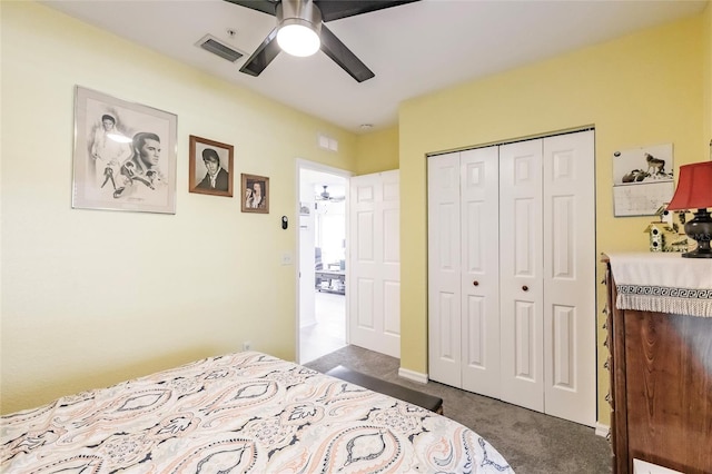 bedroom featuring a ceiling fan, visible vents, dark carpet, and a closet