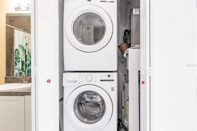 washroom with stacked washer and dryer, a sink, and laundry area