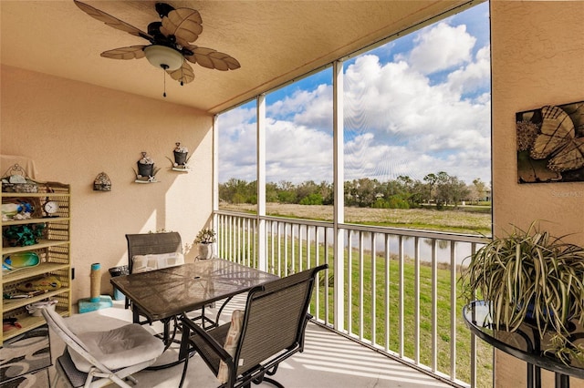 sunroom / solarium featuring ceiling fan