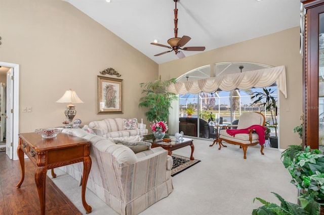 living area with high vaulted ceiling and ceiling fan