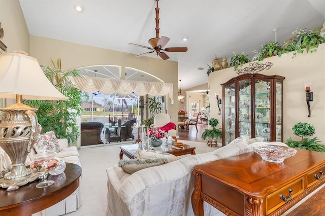 living room featuring vaulted ceiling, a ceiling fan, and recessed lighting