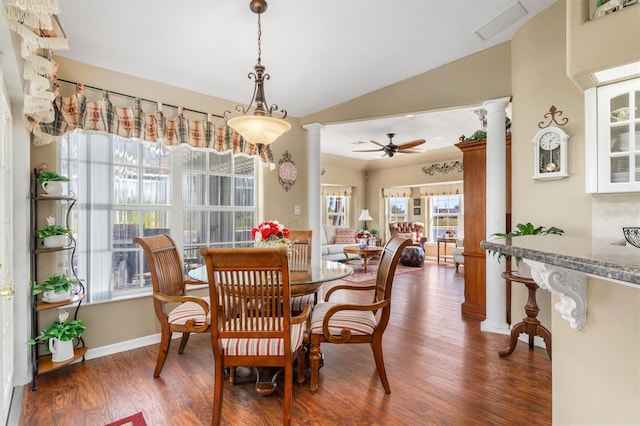 dining area featuring decorative columns, visible vents, dark wood finished floors, a ceiling fan, and vaulted ceiling