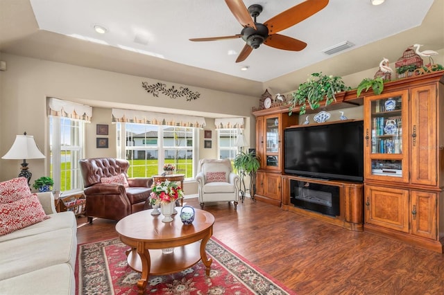 living area with ceiling fan, dark wood-style flooring, visible vents, and recessed lighting