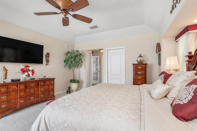 bedroom featuring light colored carpet, ceiling fan, visible vents, and baseboards