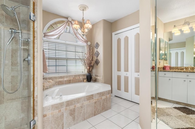 full bath with a stall shower, a garden tub, vanity, and tile patterned floors