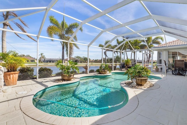 pool with a lanai, a water view, and a patio area