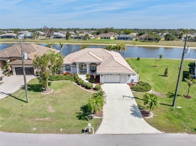 drone / aerial view with a water view and a residential view