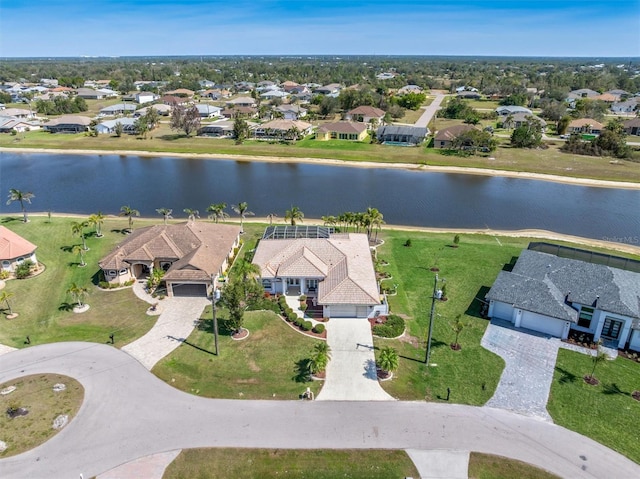 drone / aerial view featuring a residential view and a water view