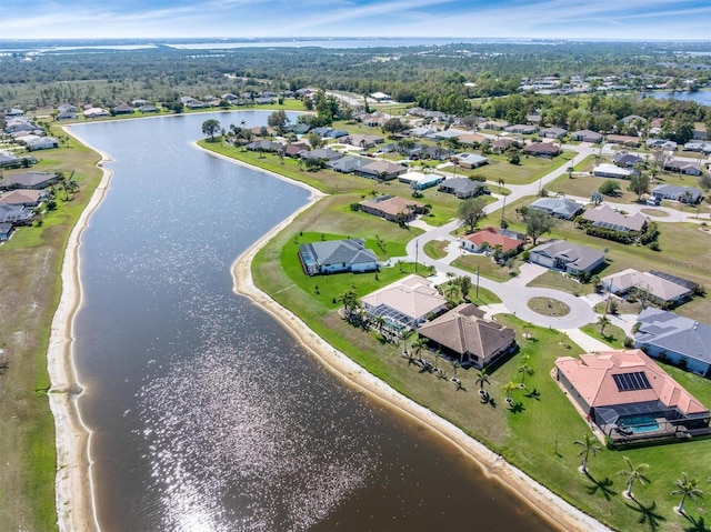 drone / aerial view with a water view and a residential view