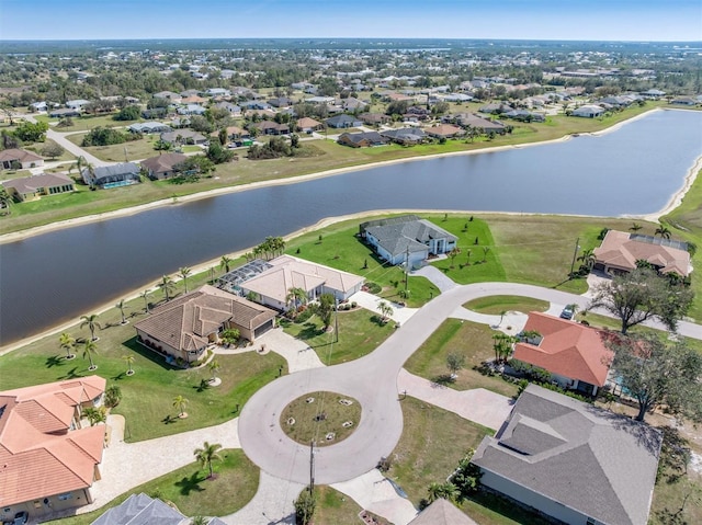 drone / aerial view featuring a water view and a residential view