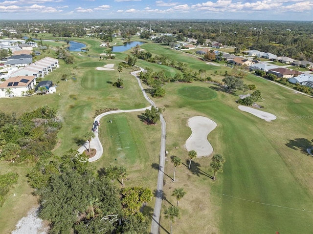 bird's eye view featuring golf course view, a water view, and a residential view