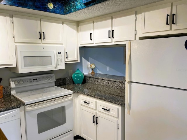 kitchen featuring white appliances and white cabinetry