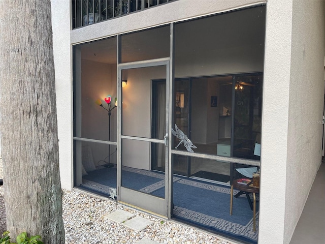 doorway to property with stucco siding