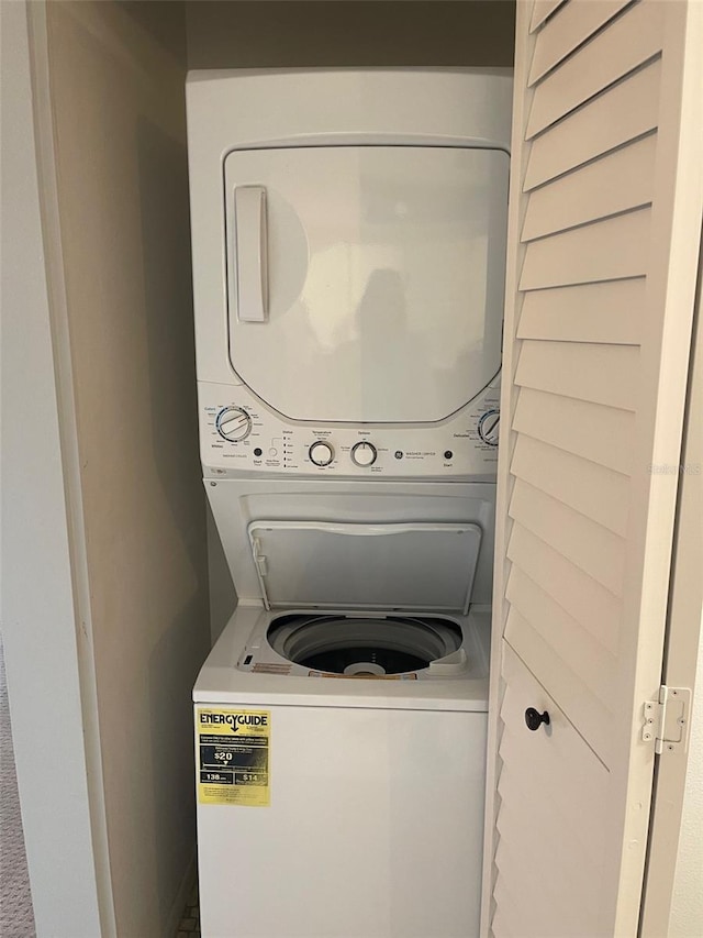 clothes washing area featuring laundry area and stacked washer and clothes dryer