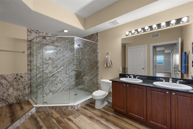 bathroom with a sink, visible vents, and wood finished floors