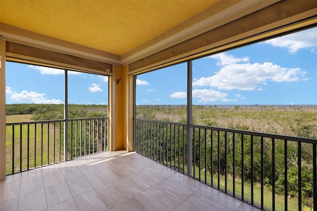 unfurnished sunroom with tile patterned floors